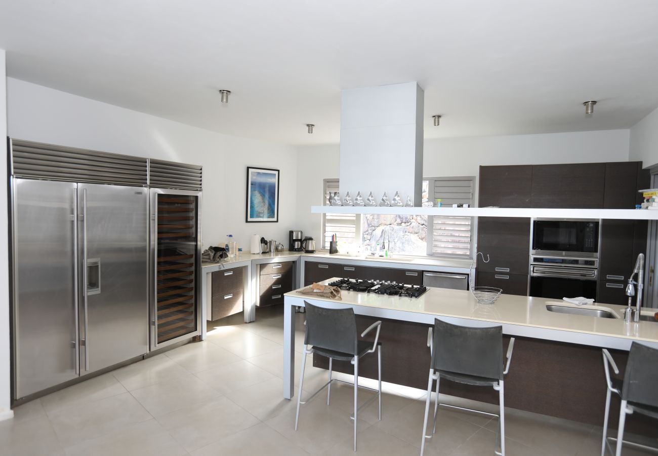 Large kitchen, circular dining, stainless steel appliances, at Galley Bay villa rentals, Antigua