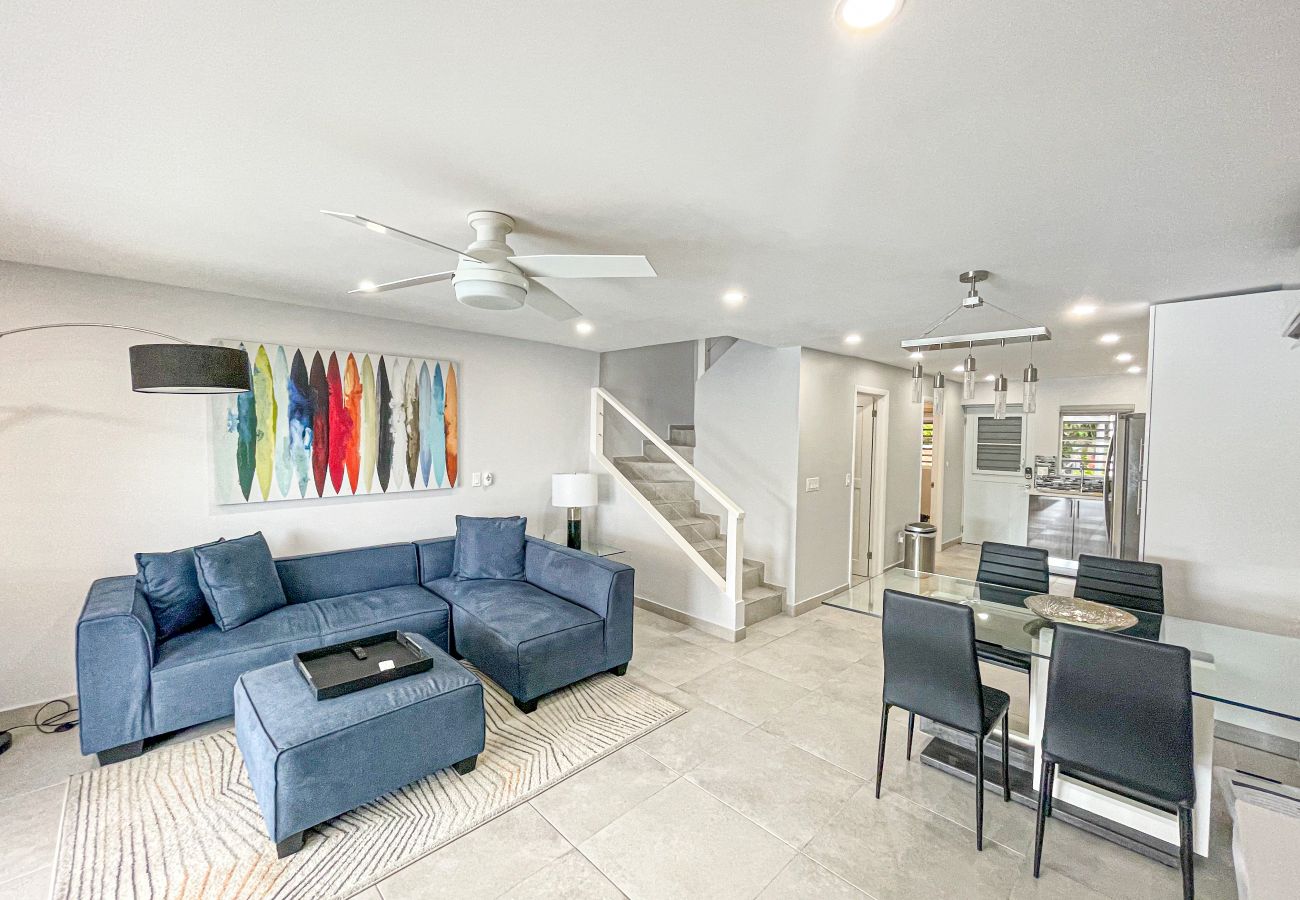 Open plan living room with an L-shaped sofa, Office workspace and Air Conditioning at Jolly Harbour Villa rentals