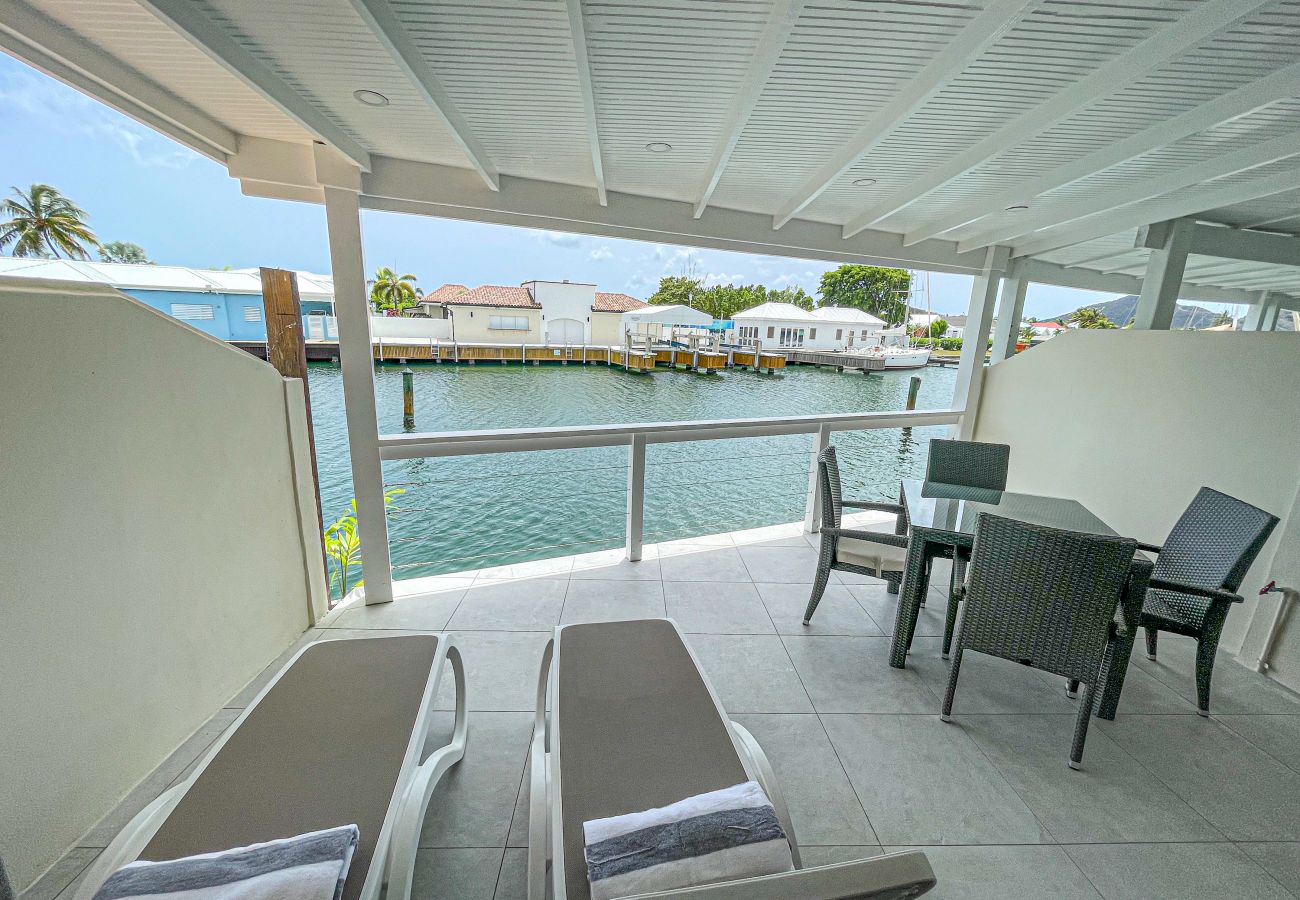 Beautiful waterfront views, outdoor dining with sun loungers at Jolly Harbour Villa rentals