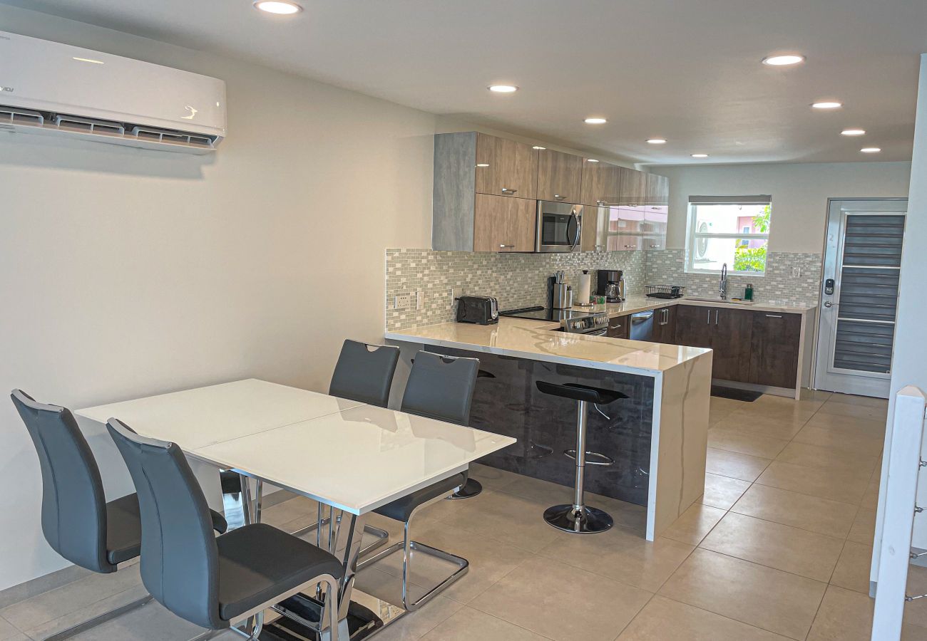  Fully equipped kitchen with stylish shades of grey, with marble countertops, indoor dining at Jolly Harbour villa rentals