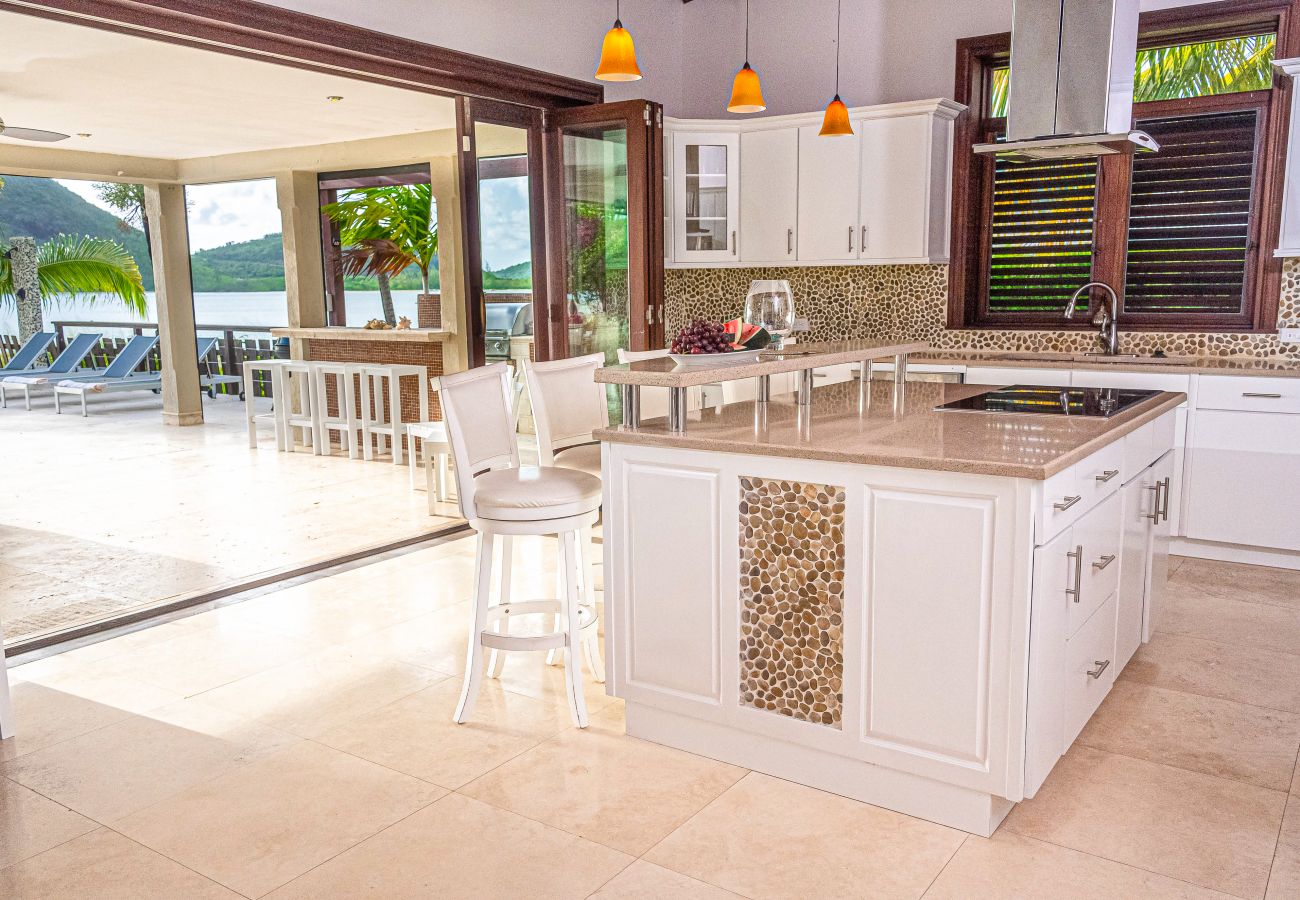 Luxurious Kitchen with a vast covered terrace, full barbeque suite,and amazing ocean views at Jolly Harbour Villa rentals