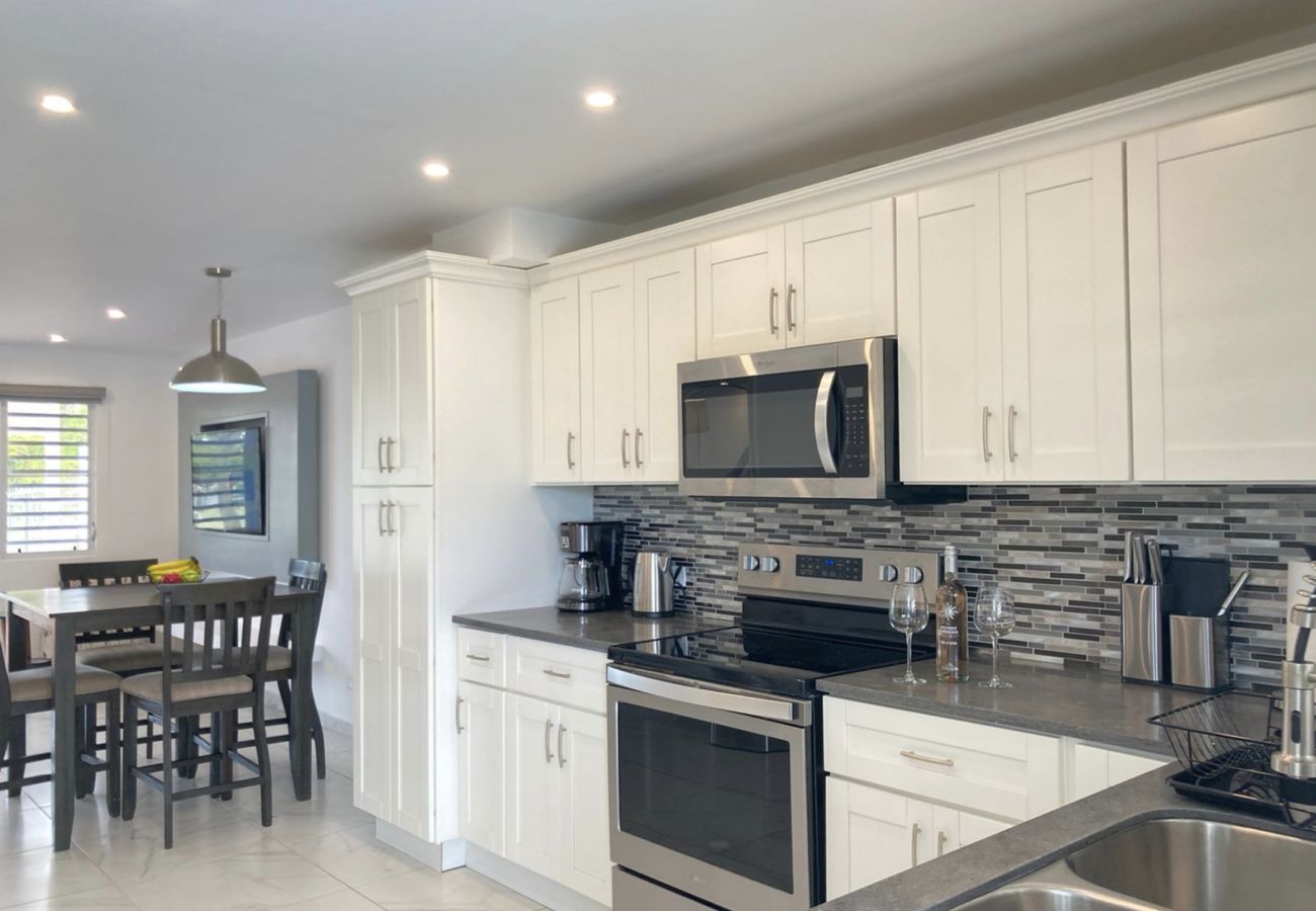 Jolly Harbour Villa Rentals, Fully equipped, open plan, L-shaped kitchen,Indoor and outdoor dining with garden views