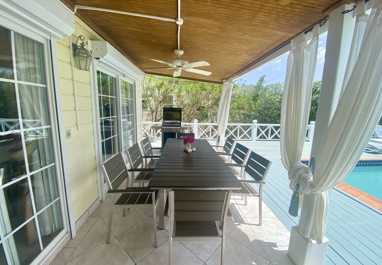 Outdoor dining with private pool, vast sundeck, BBQ grill, Loungers, and shaded verandah at Harbour View Villa rentals