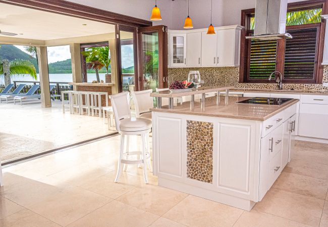 Luxurious Kitchen with a vast covered terrace, full barbeque suite,and amazing ocean views at Jolly Harbour Villa rentals