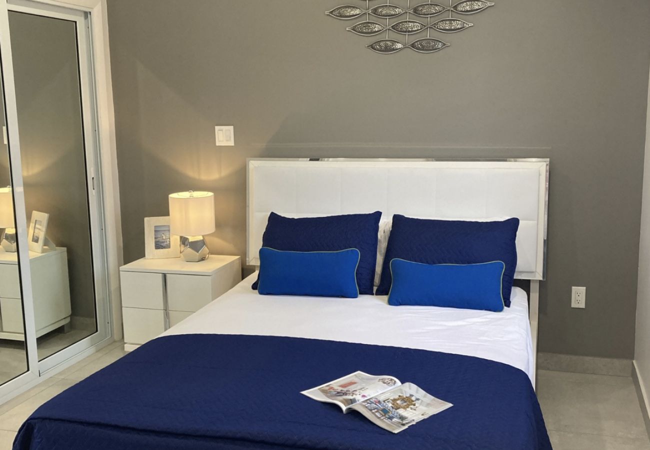 Modern Two-bedroom Waterfront Villa with ensuite shower rooms with queen-sized bed at Jolly Harbour Villa Rentals