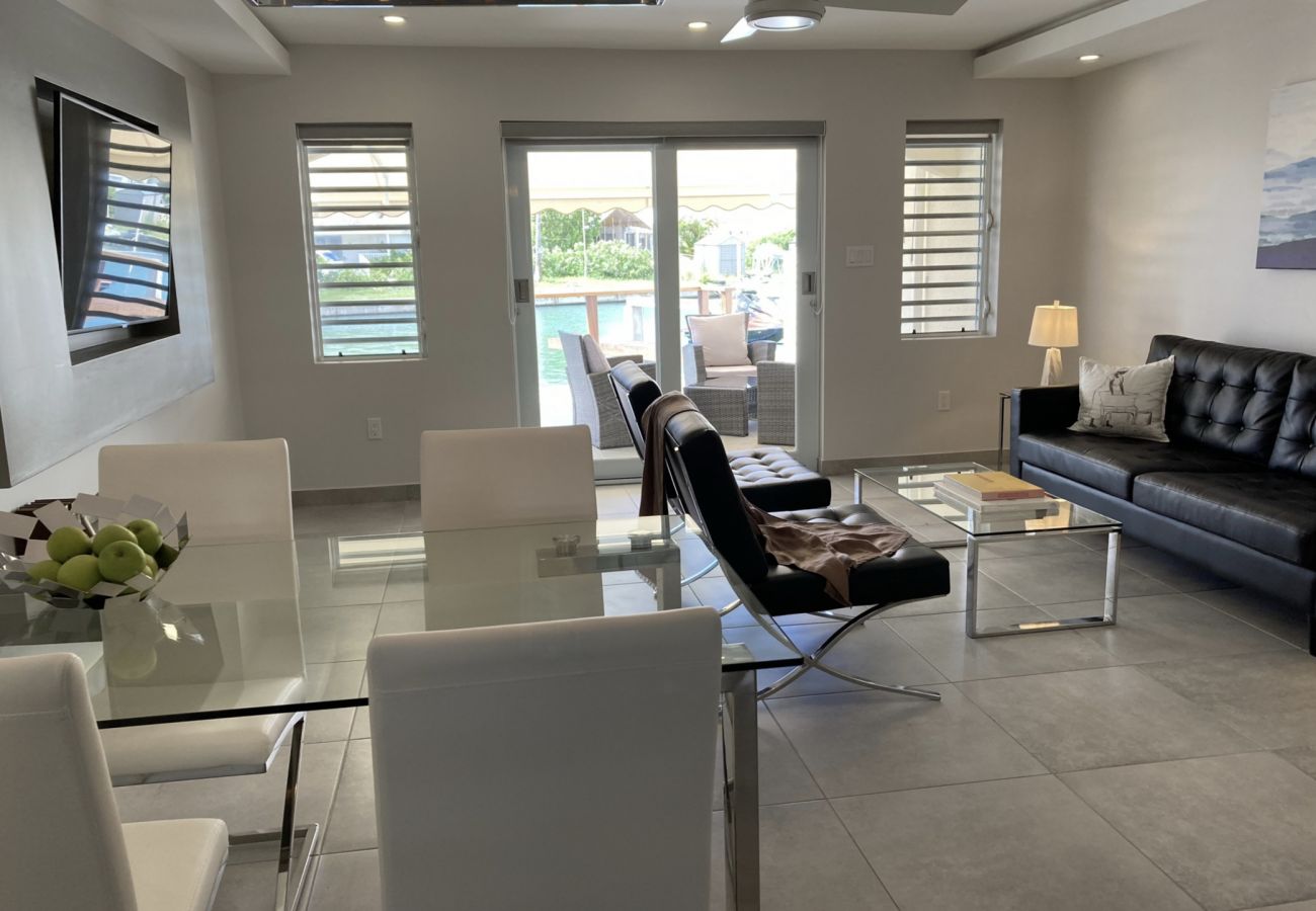 Jolly Harbour Villa rentals, waterfront terrace, leather chair set, outdoor dining, air conditioning and Ceiling fans