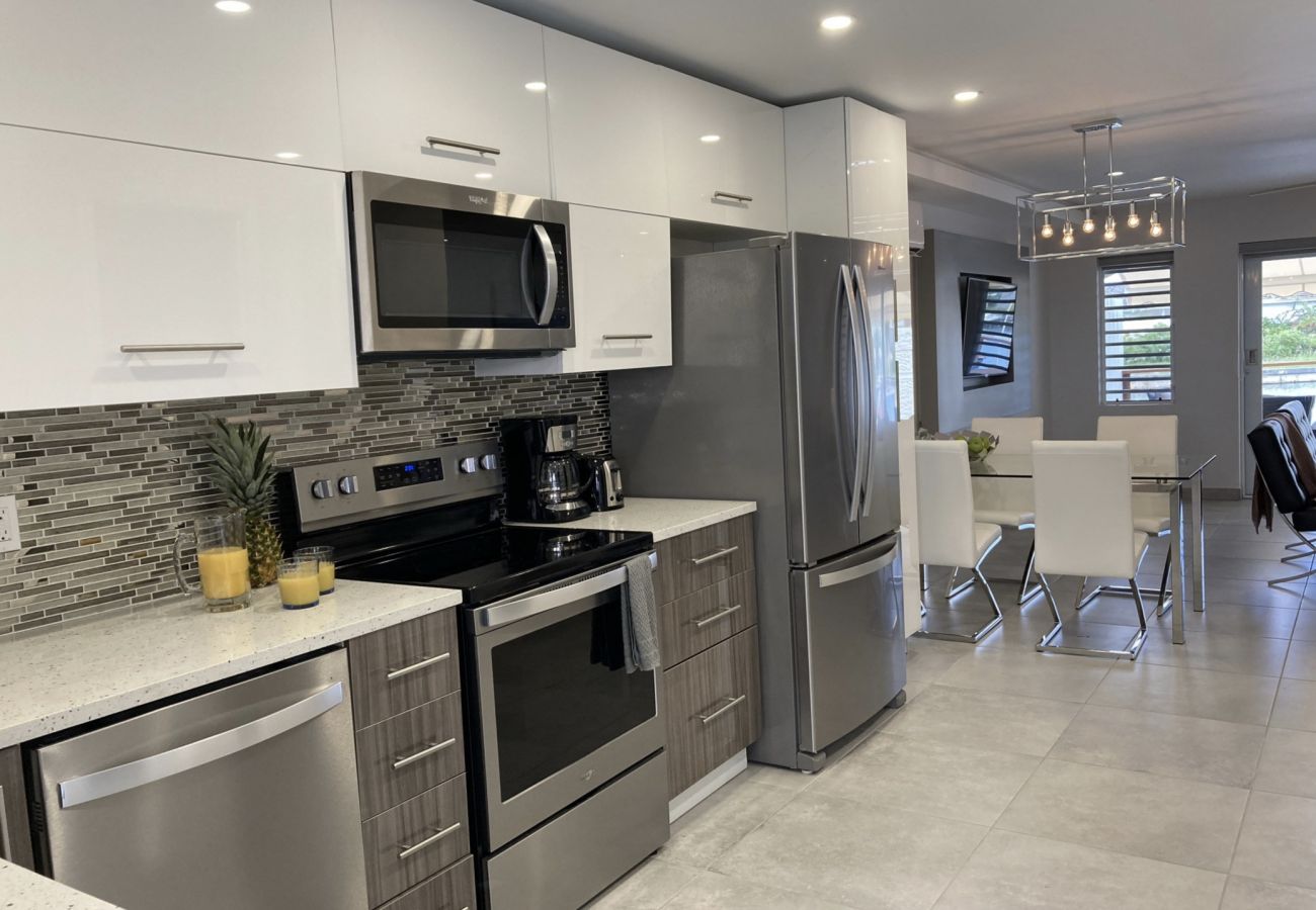 Two-bedroom waterfront villa with a fully equipped open-plan kitchen with modern appliances at Jolly Harbour Villa Rentals 