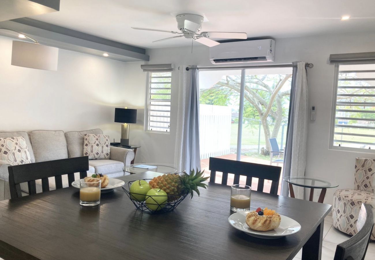 Modern Two-bedroom villa decorated with a grey L-shaped sofa, two coffee tables at Jolly Harbour Villa rentals