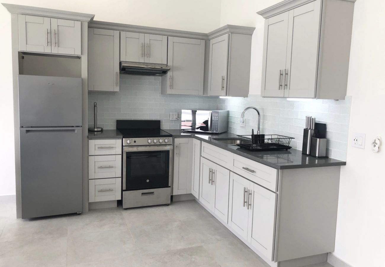 Bright open kitchen with modern appliances at Jolly Harbour villa rentals